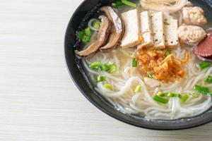 Vietnamese Rice Noodles Soup with Vietnamese Sausage served vegetables and crispy onion photo