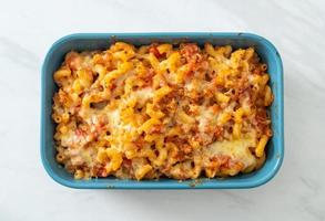 homemade macaroni bolognese with cheese photo