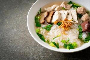 Vietnamese Rice Noodles Soup with Vietnamese Sausage served vegetables and crispy onion photo