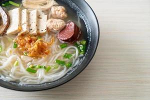 Vietnamese Rice Noodles Soup with Vietnamese Sausage served vegetables and crispy onion photo