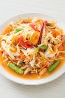 Som Tum - Thai Spicy green papaya salad with salty eggs photo