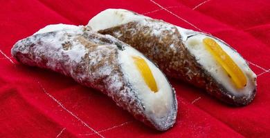 Sweet Cannolo Siciliano. Traditional south Italian dessert. Delicious Sicilian Cannolo filled with ricotta cheese. photo