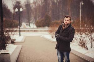 Handsome young man outdoor in winter coat photo