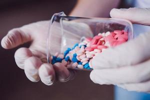 doctor holds bottle of pills in hand photo