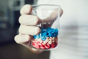 Pharmaceutical worker with pills photo