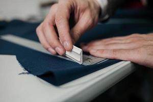 close-up of the fingers of a tailor photo