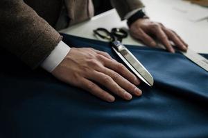 tailor's hands on the fabric photo