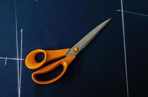 Tailoring scissors on the fabric photo