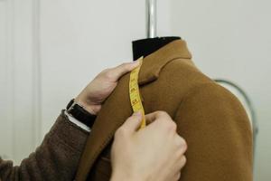 a tailor with a ribbon measure photo