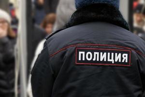 Back of a russian policeman wearing an uniform with an emblem photo