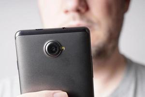 unrecognizable man looking at smart phone photo