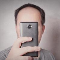 man taking picture with smart phone photo