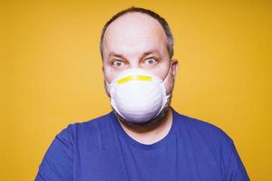 man with face mask and panic in his eyes photo
