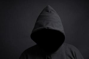faceless person with black hoody photo