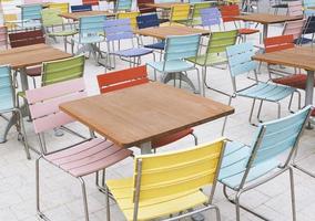 empty deserted street cafe or outdoor restaurant tables with multicolored chairs photo