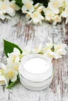 Moisturizing cream with jasmine flowers photo