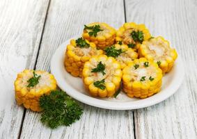 Plate with boiled corn on the cob photo