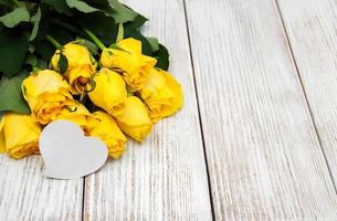 Yellow roses on a table photo