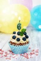 Cupcake with a numeral six candle photo
