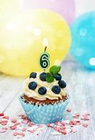 Cupcake with a numeral six candle photo