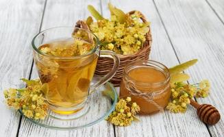 cup of herbal tea with linden flowers photo