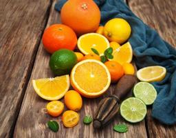 Fresh citrus fruits and old juicer photo