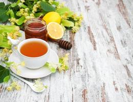 cup of herbal tea with linden flowers photo