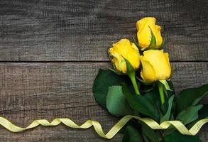 Yellow roses on a table photo