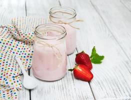 Jars with yogurt and  strawberries photo