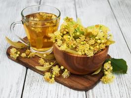 cup of herbal tea with linden flowers photo