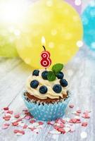 Cupcake with a numeral eight candle photo