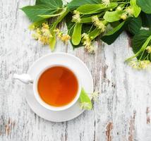 cup of herbal tea with linden flowers photo