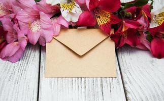 paper envelope with alstroemeria flowers photo