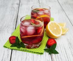 Glasses of lemonade with strawberries photo