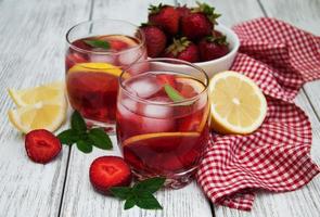 Glasses of lemonade with strawberries photo