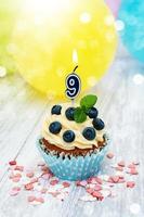 Cupcake with a numeral nine candle photo