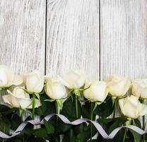 White roses on a wooden table photo