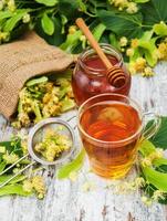 cup of herbal tea with linden flowers photo