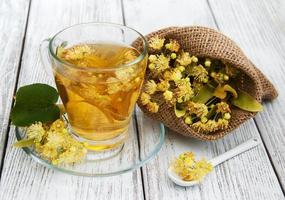 cup of herbal tea with linden flowers photo