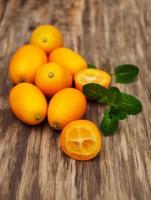 Kumquats on a wooden table photo