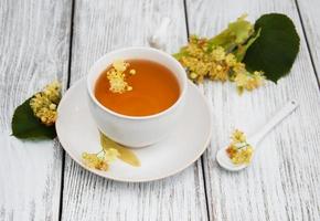 cup of herbal tea with linden flowers photo