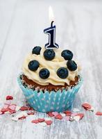 Cupcake with a numeral one candle photo