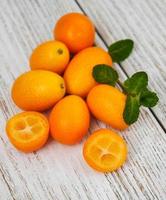 Kumquats on a wooden table photo