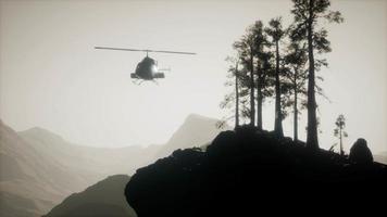 extreme slow motion flying helicopter near mountain forest video