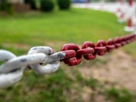 The fence is a large white and red chain photo