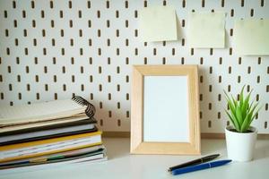 Desktop with notebooks pencils and photo frame