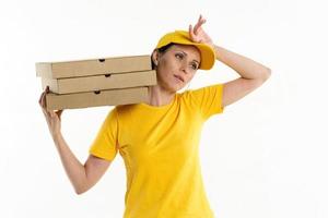 Delivery woman with pizza in cardboard boxes on background photo