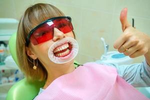 dentistry happy patient in the chair in goggles photo