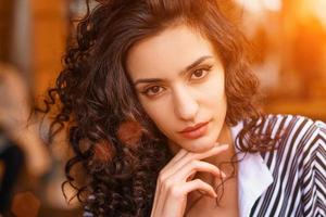 portrait of a beautiful young woman with curly hair closeup photo