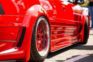 Red sports tuned car rear view of the wheel, close-up . photo